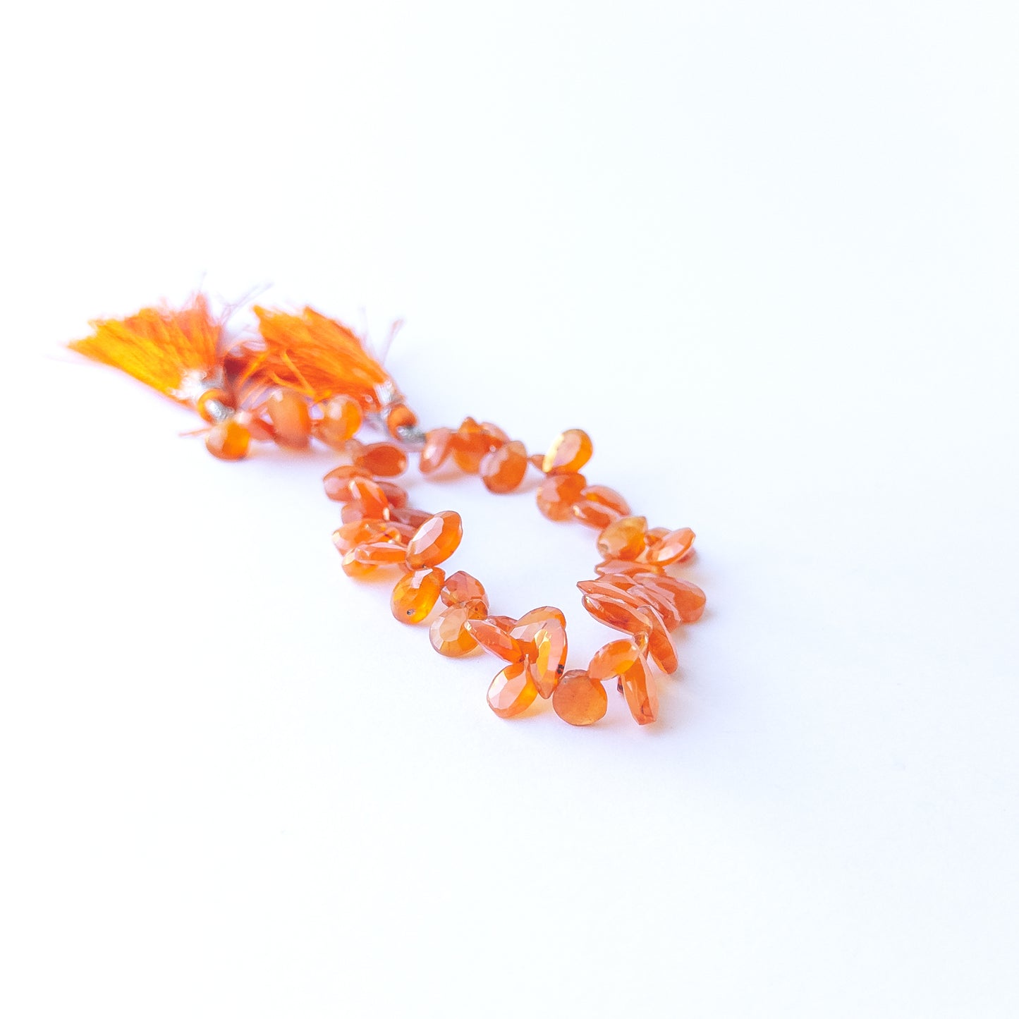 Handmade jewellery components featuring smooth, sparkling Carnelian briolette gemstone beads.