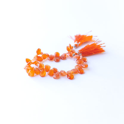 Genuine Carnelian gemstone beads with faceted briolette cut perfect for artisan jewellery designs.