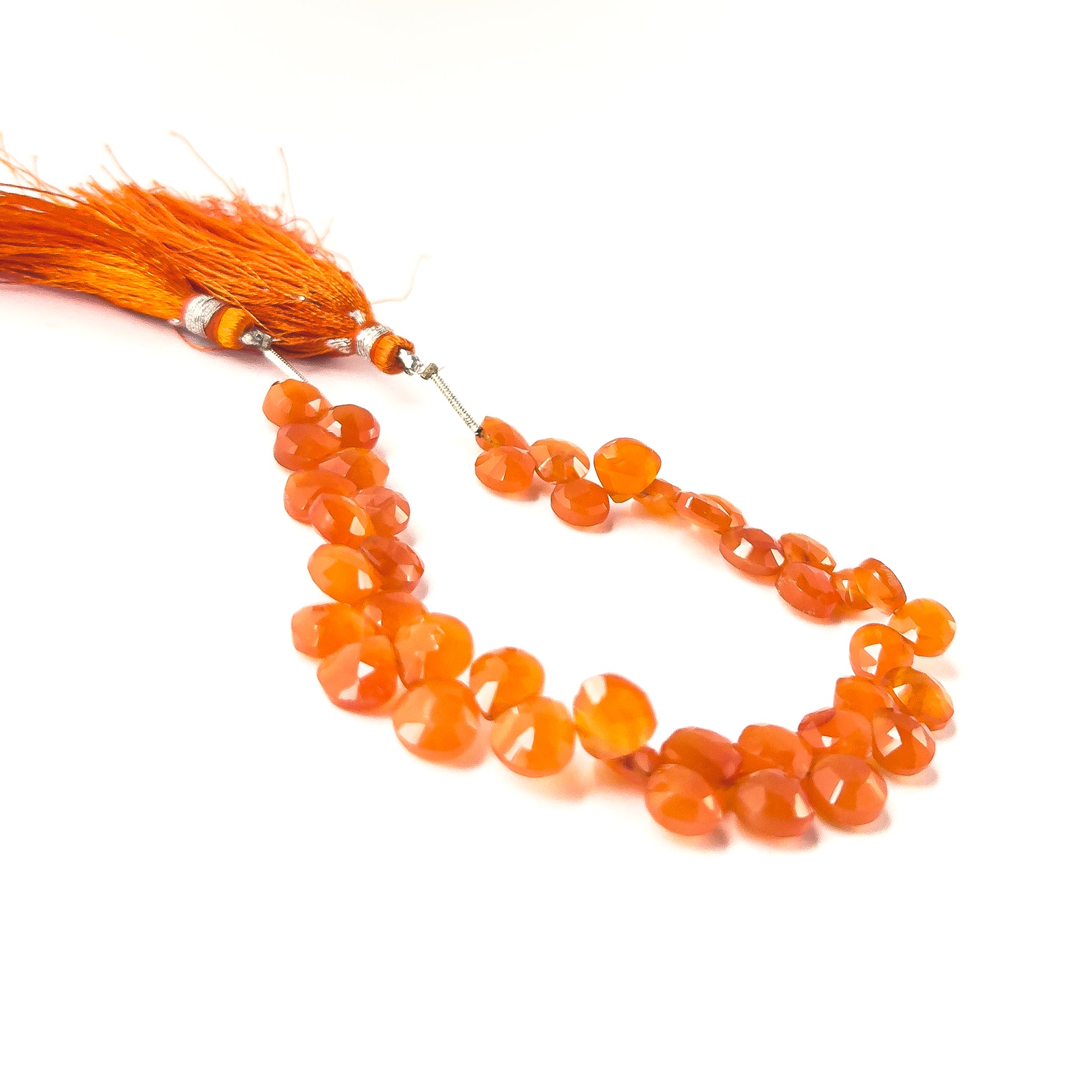 Natural Carnelian stones in faceted briolette form, offering vivid colour saturation and elegant teardrop shaping.