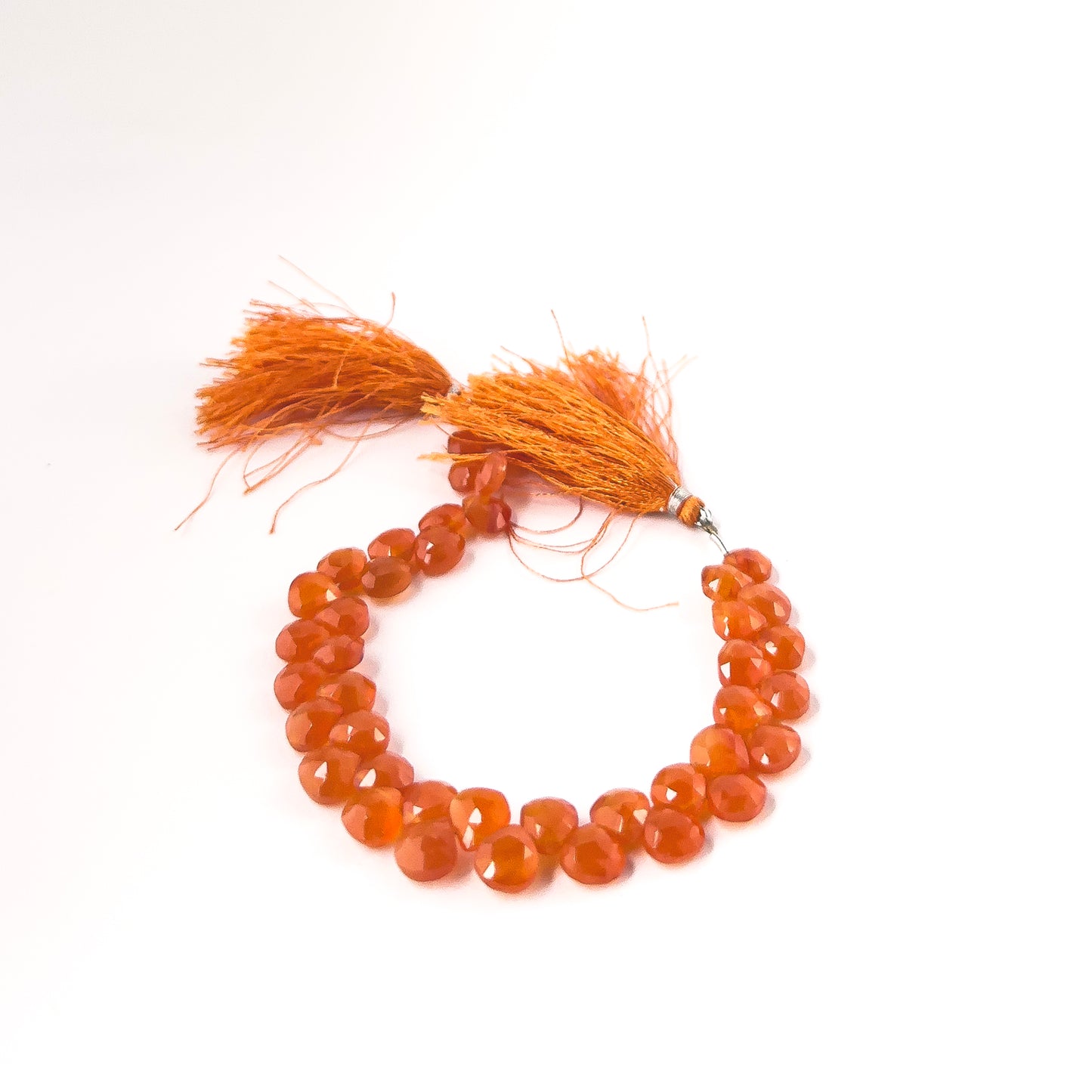 Genuine Carnelian faceted briolette gemstone beads with bright fiery colour and polished brilliance in a 20cm strand.