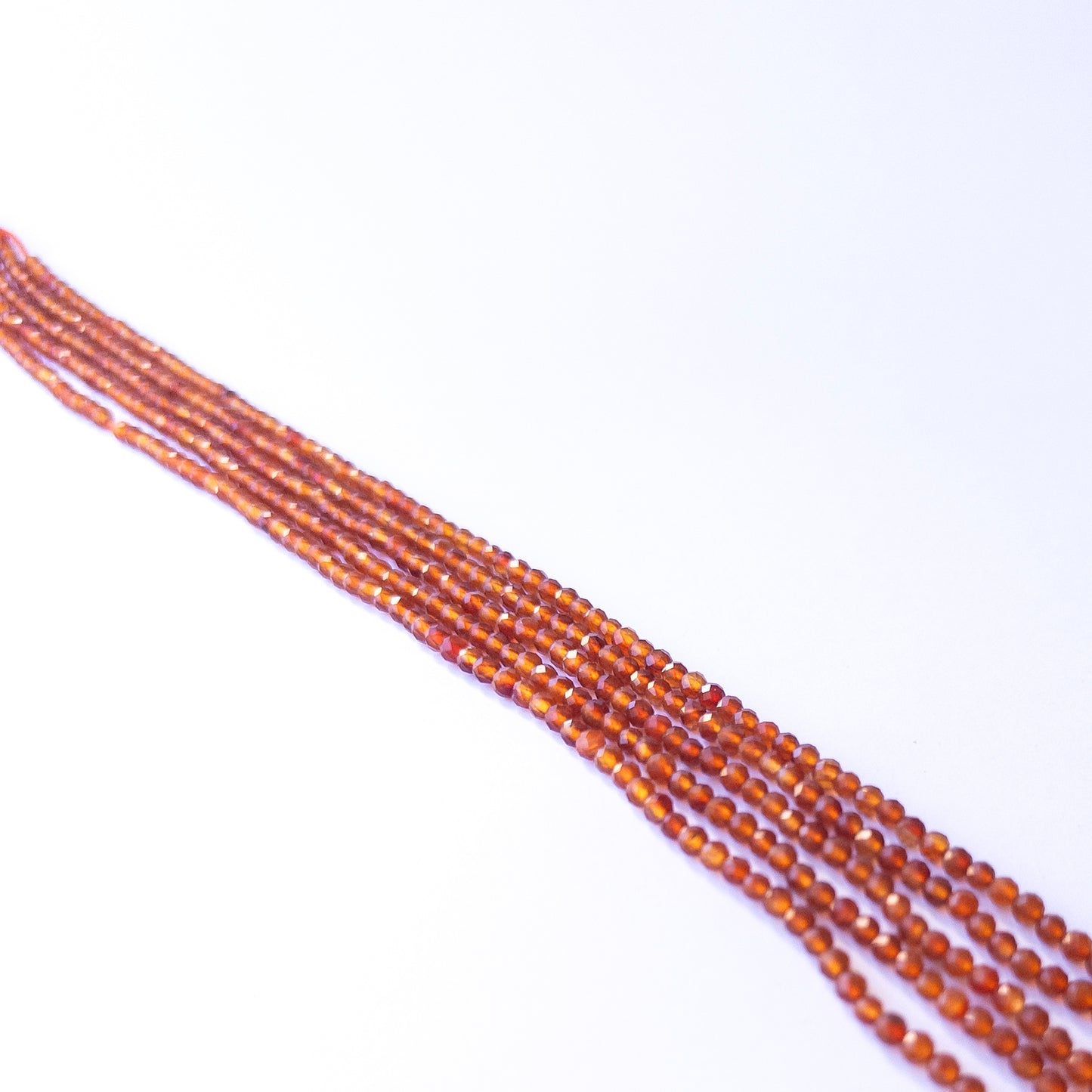 Genuine Carnelian gemstone beads in faceted rondelle shape, displaying polish, shimmer, and natural beauty for jewellery crafting.