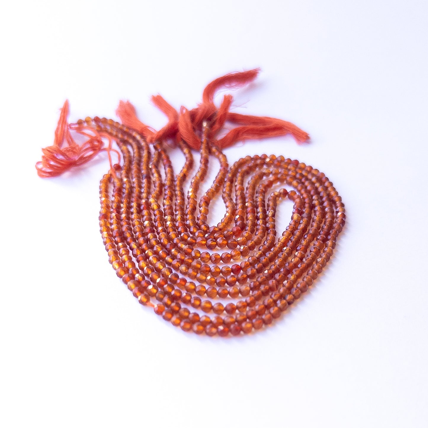 Carnelian faceted rondelle beads with natural variation, perfect for handmade jewellery components and creative beadwork.