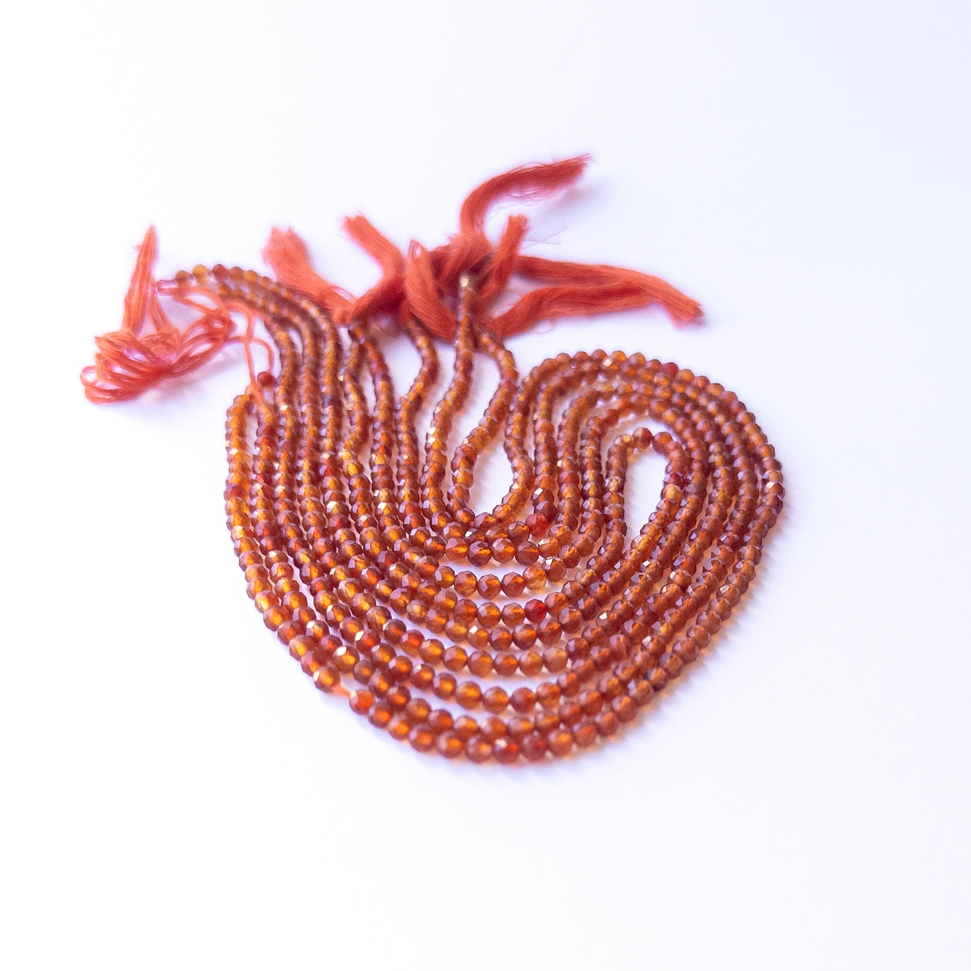 Carnelian faceted rondelle beads with natural variation, perfect for handmade jewellery components and creative beadwork.
