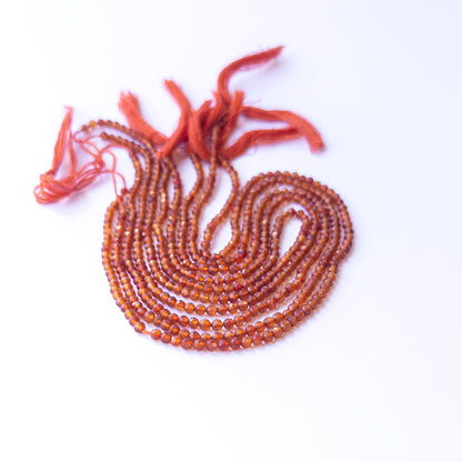 Close‑up of authentic Carnelian faceted rondelle stone beads highlighting sparkle, colour, and quality for DIY jewellery making.