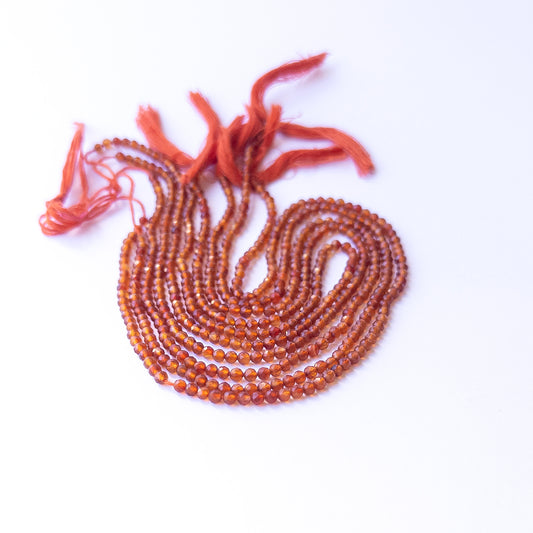 Close‑up of authentic Carnelian faceted rondelle stone beads highlighting sparkle, colour, and quality for DIY jewellery making.
