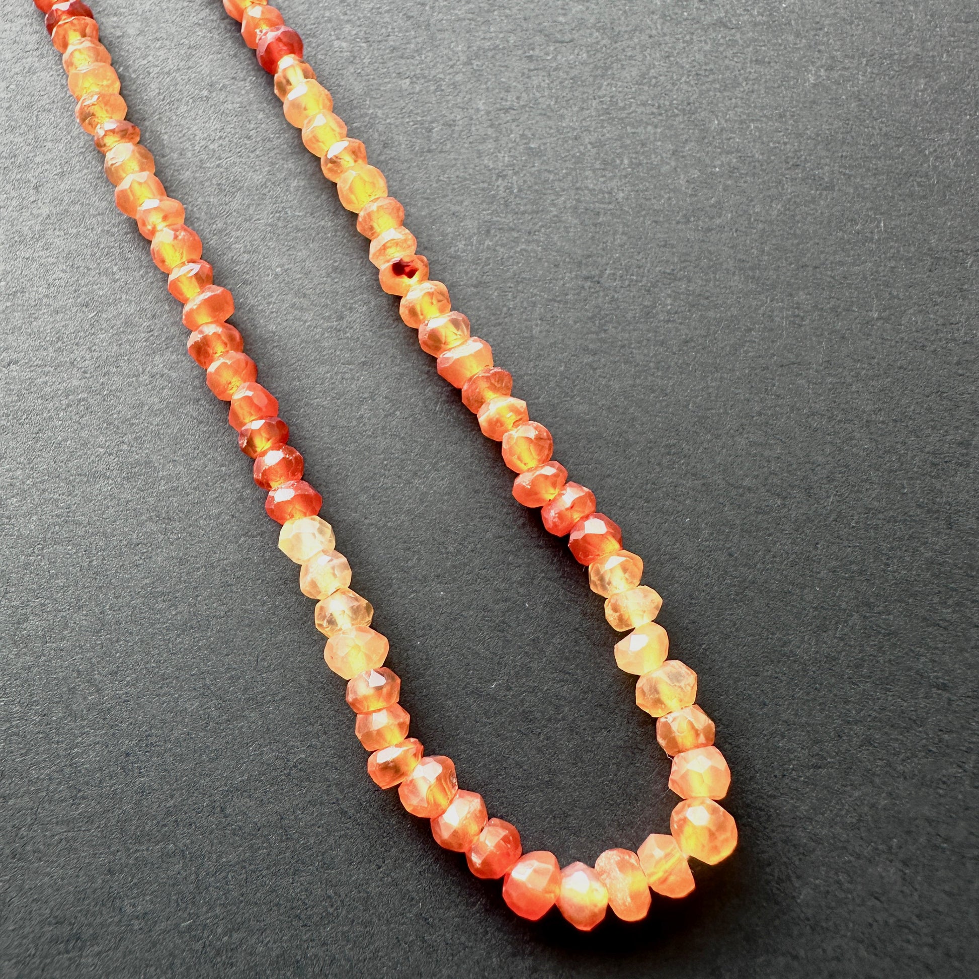 Close-up of Carnelian beads showcasing their sparkle and rich hue.