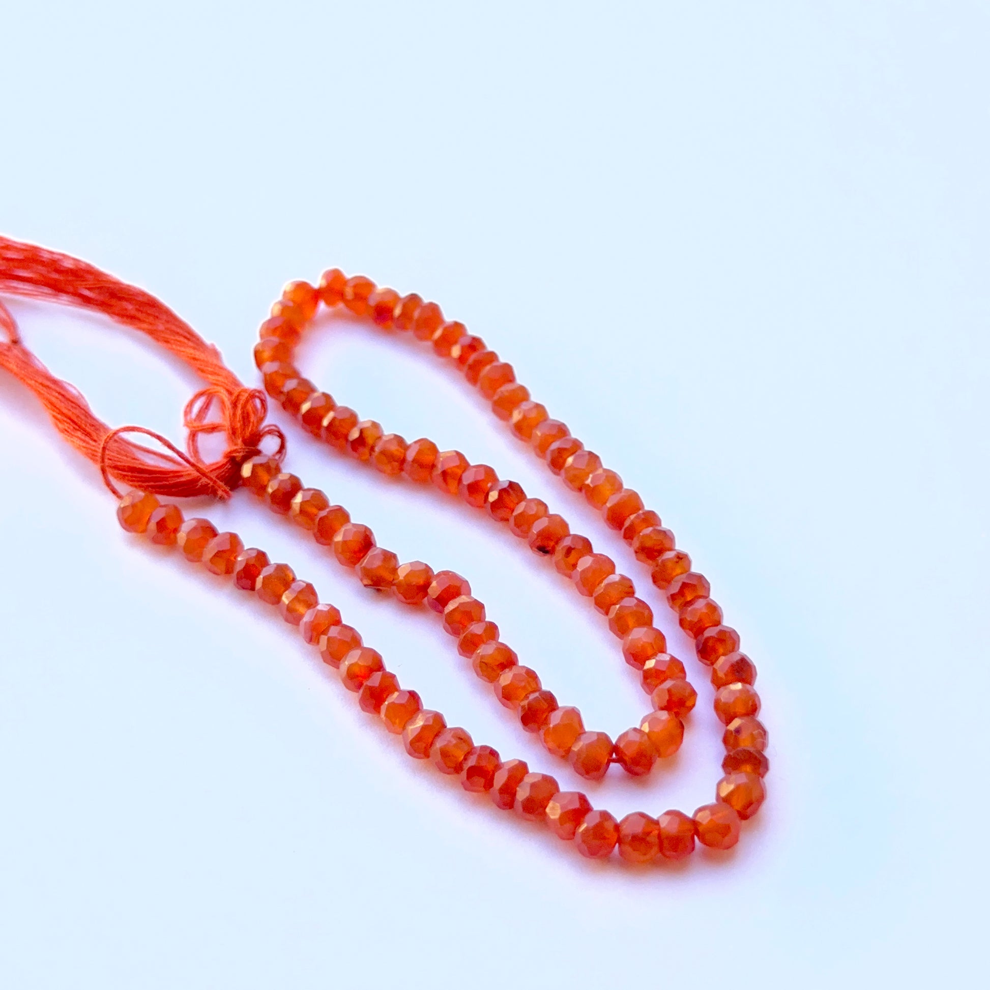 Close‑up of 4.3–4.5mm Carnelian stone beads showing sparkling facets and warm colour ideal for natural gemstone beads for DIY jewellery.