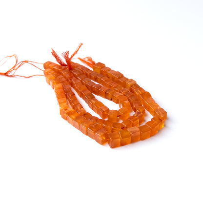 Genuine Carnelian cube beads showcasing polished shine and vibrant colour for jewellery crafting.