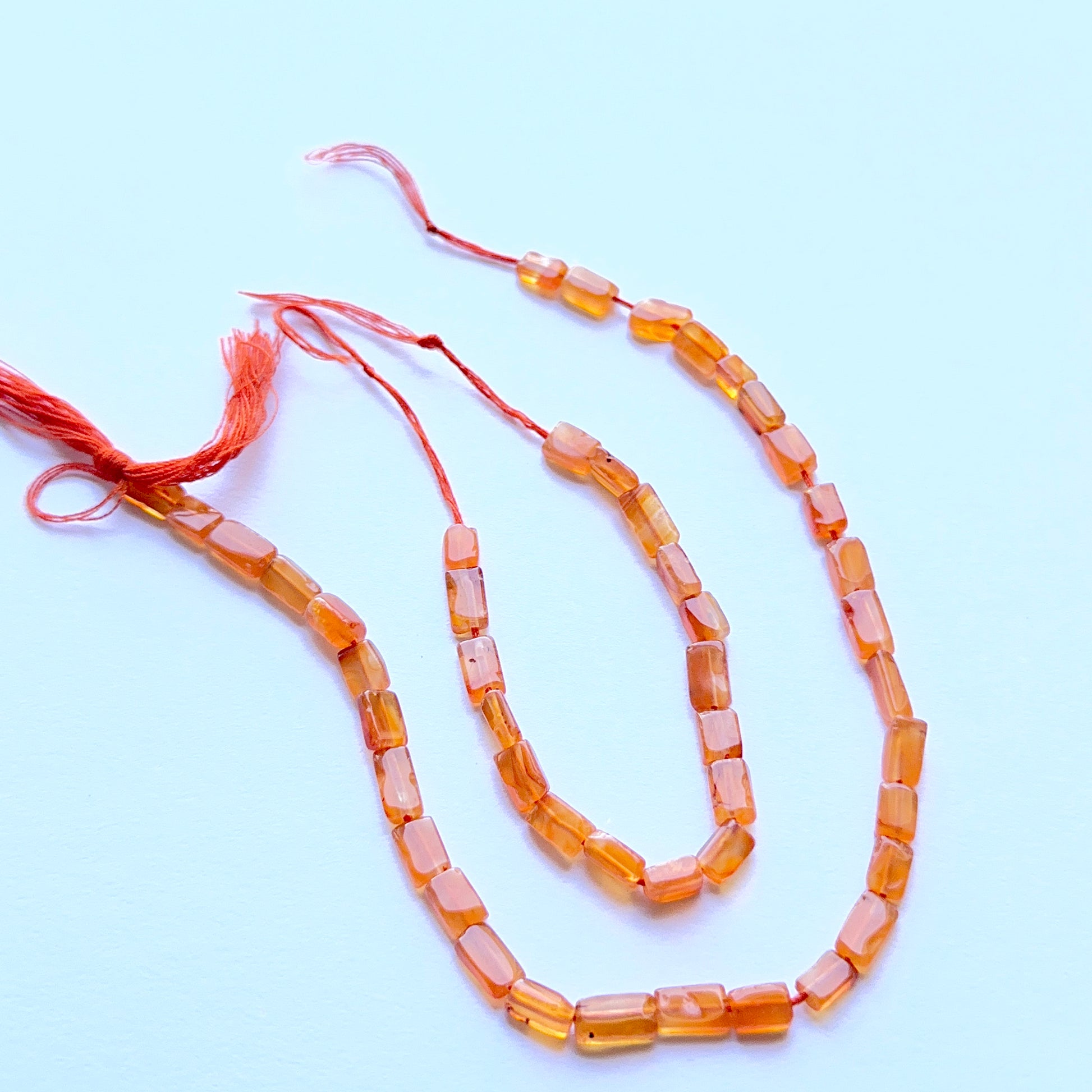 Close‑up of 4.1–4.5mm Carnelian stone beads showing polished rectangular cuts ideal for natural gemstone beads for DIY jewellery.