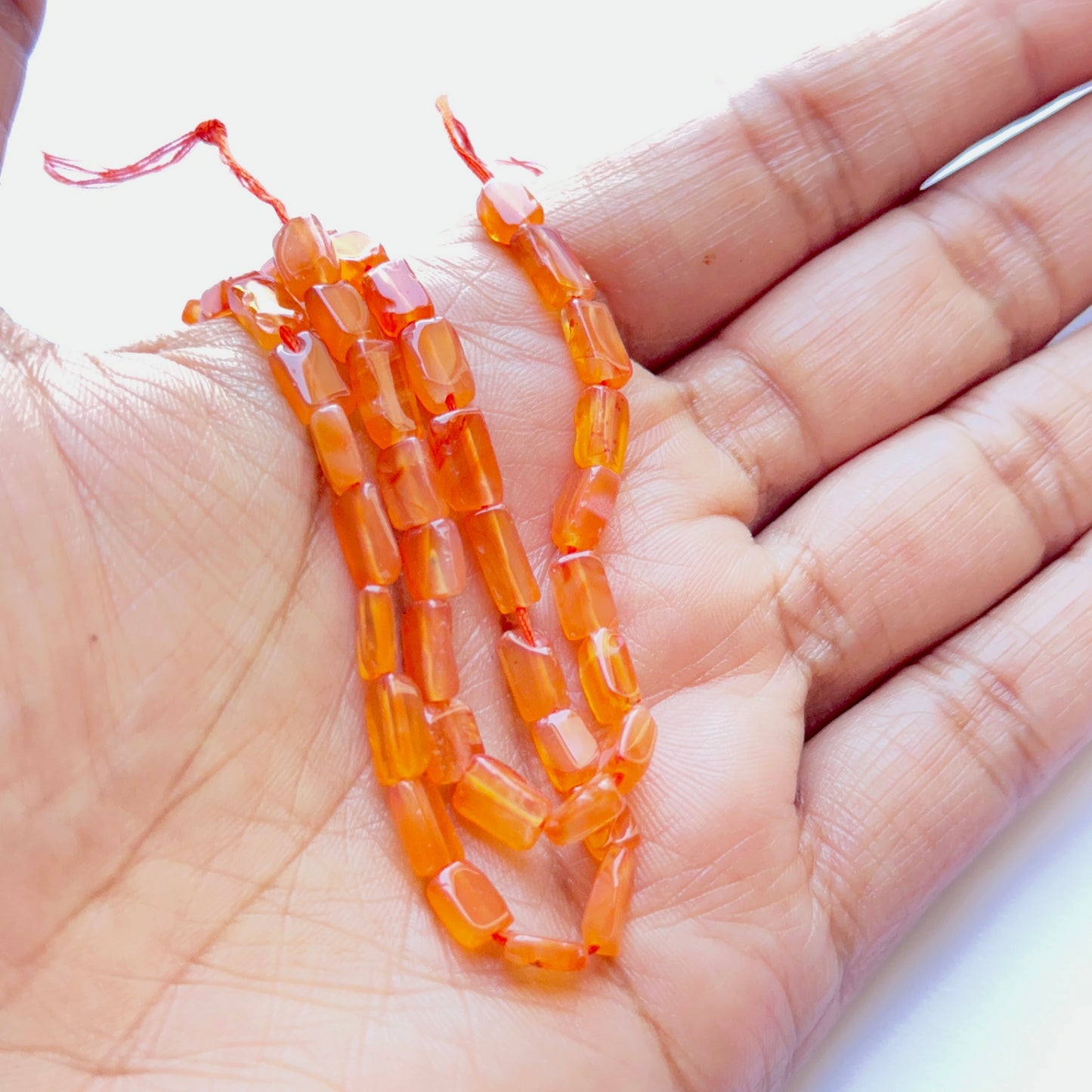 Detailed view of premium Carnelian stone beads showing uniform shape, rich colour and high‑quality finish.