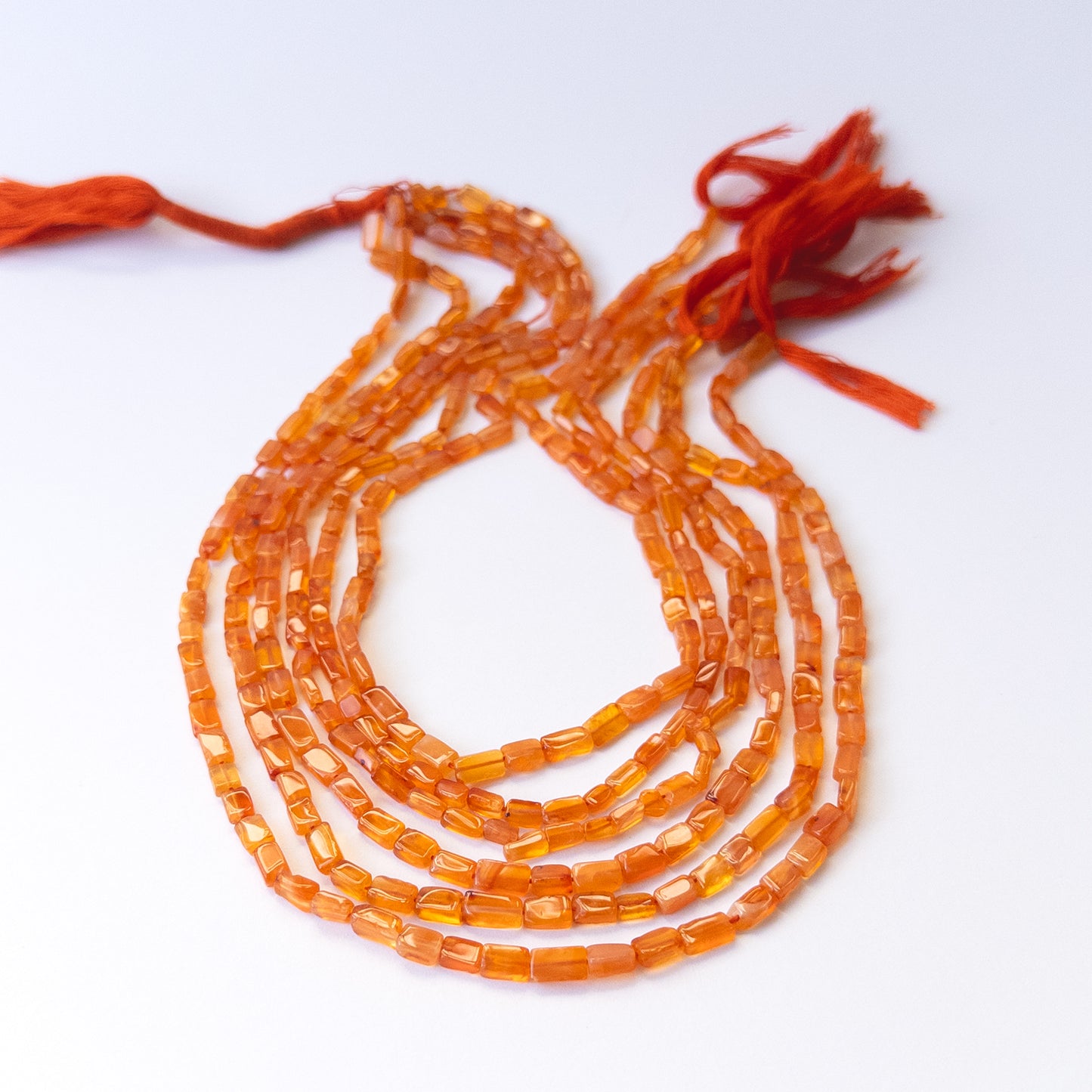 Natural Carnelian stone beads with warm orange tones and smooth rectangle shapes for artisan jewellery.