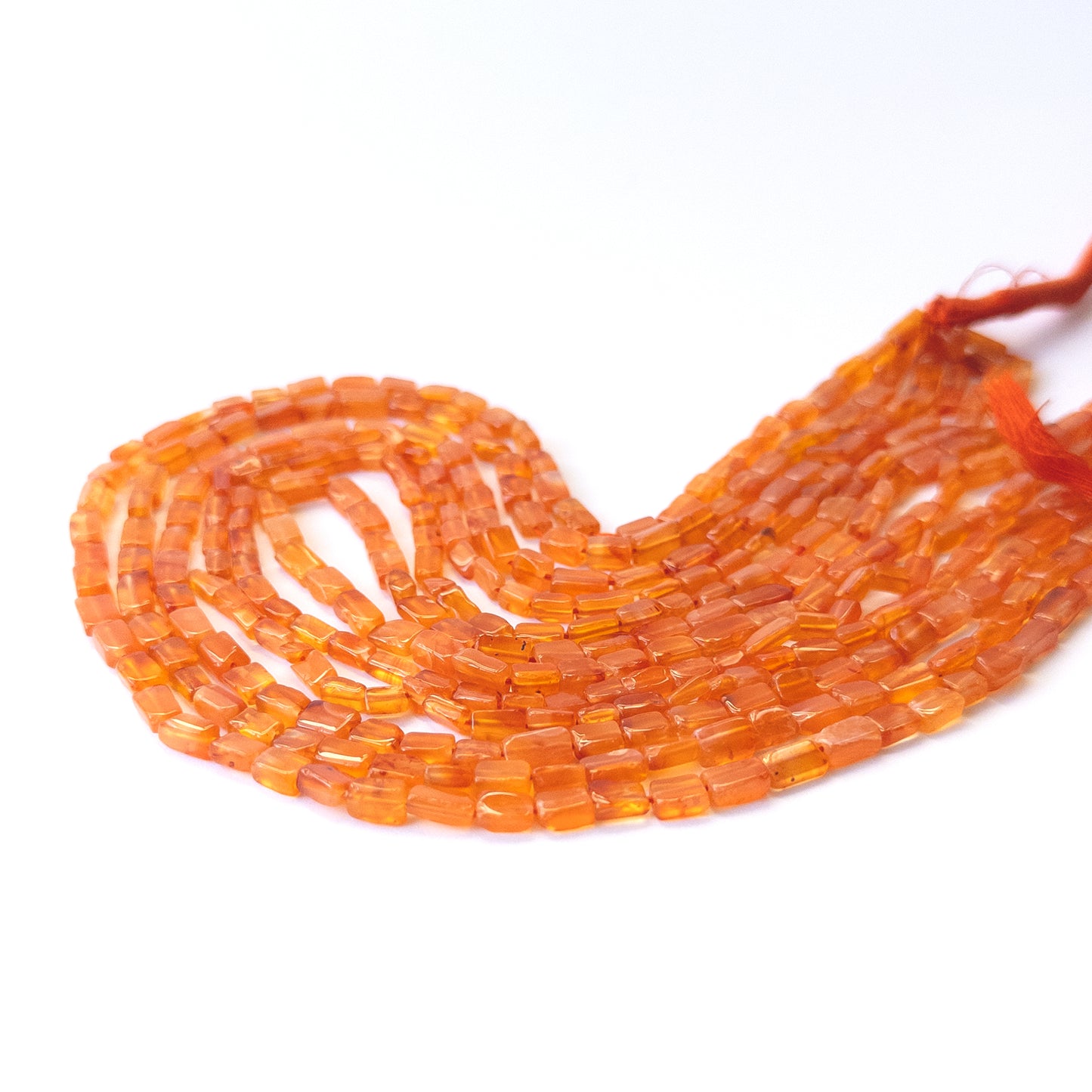 Genuine Carnelian gemstone beads showcasing smooth rectangle cuts arranged neatly on a 37cm strand.