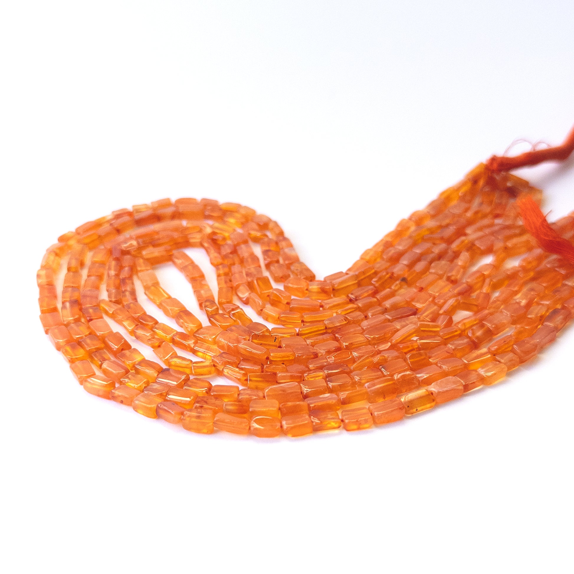 Genuine Carnelian gemstone beads showcasing smooth rectangle cuts arranged neatly on a 37cm strand.