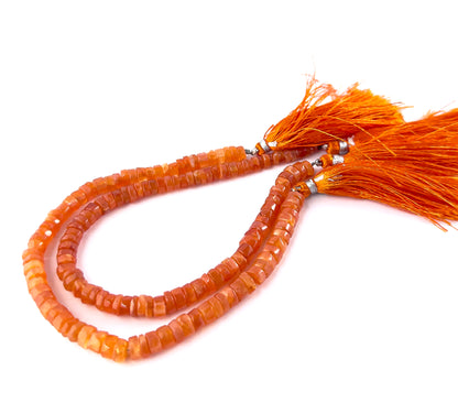 Carnelian wheel beads featuring smooth surfaces and a gradual 4.8–8.5mm size variation for a textured, graduated look.