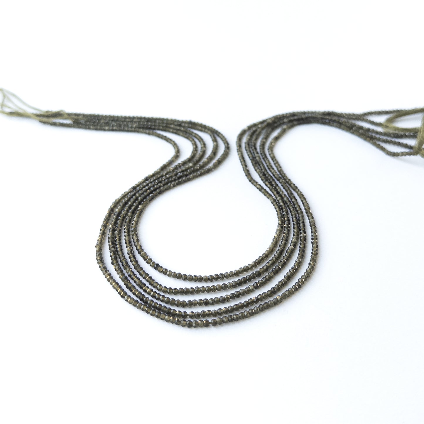 Cat's Eye faceted rondelle gemstone beads in 2mm size arranged on a 33cm strand with soft reflective shine.