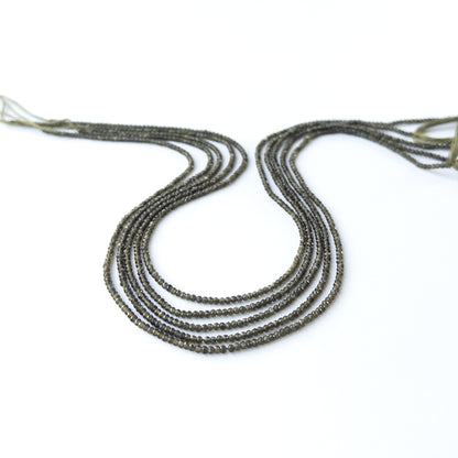 Cat's Eye faceted rondelle gemstone beads in 2mm size arranged on a 33cm strand with soft reflective shine.