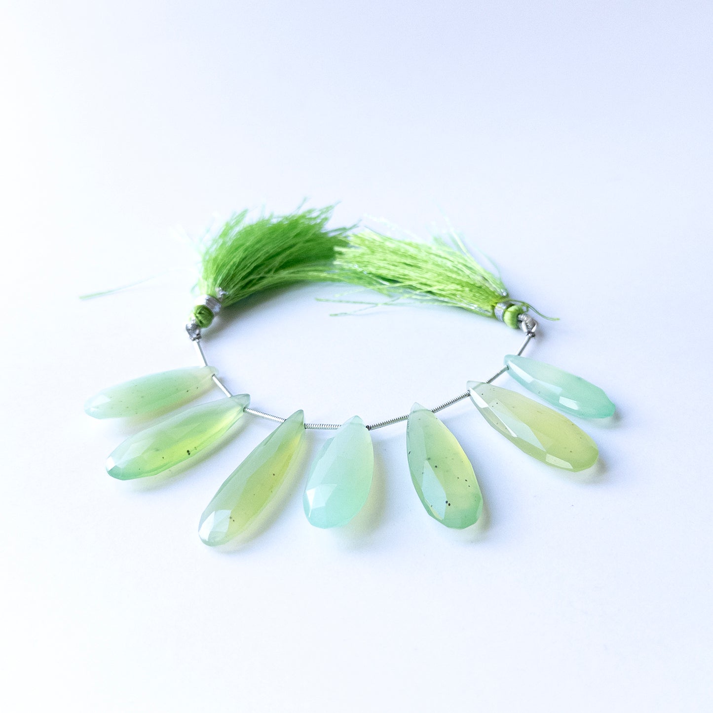 Genuine Chalcedony gemstone beads displaying soft blue tones, polished facets, and beautifully elongated shapes for jewellery design.