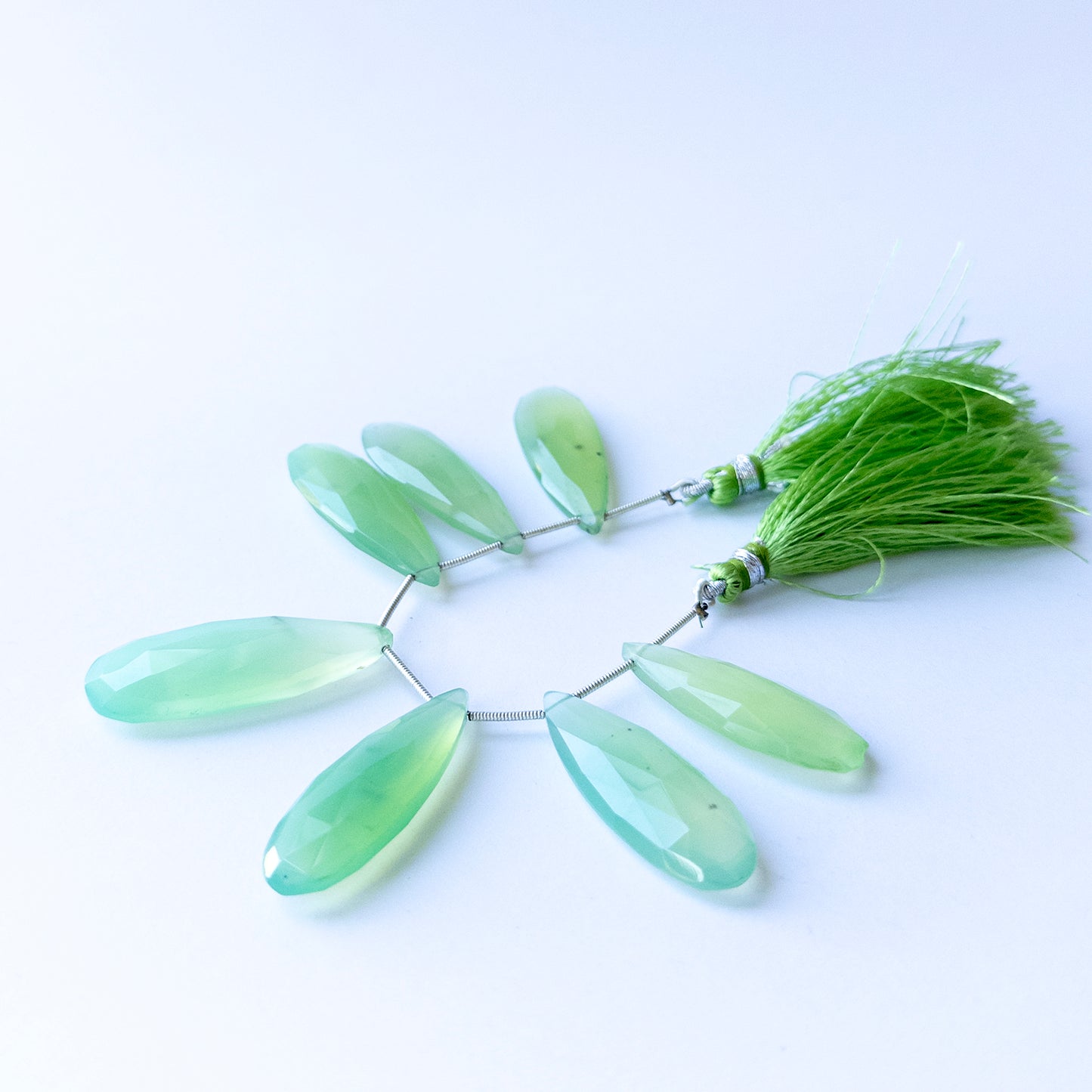 Handmade jewellery components featuring natural Chalcedony faceted briolettes, highlighting their clarity, colour, and elegant teardrop form.