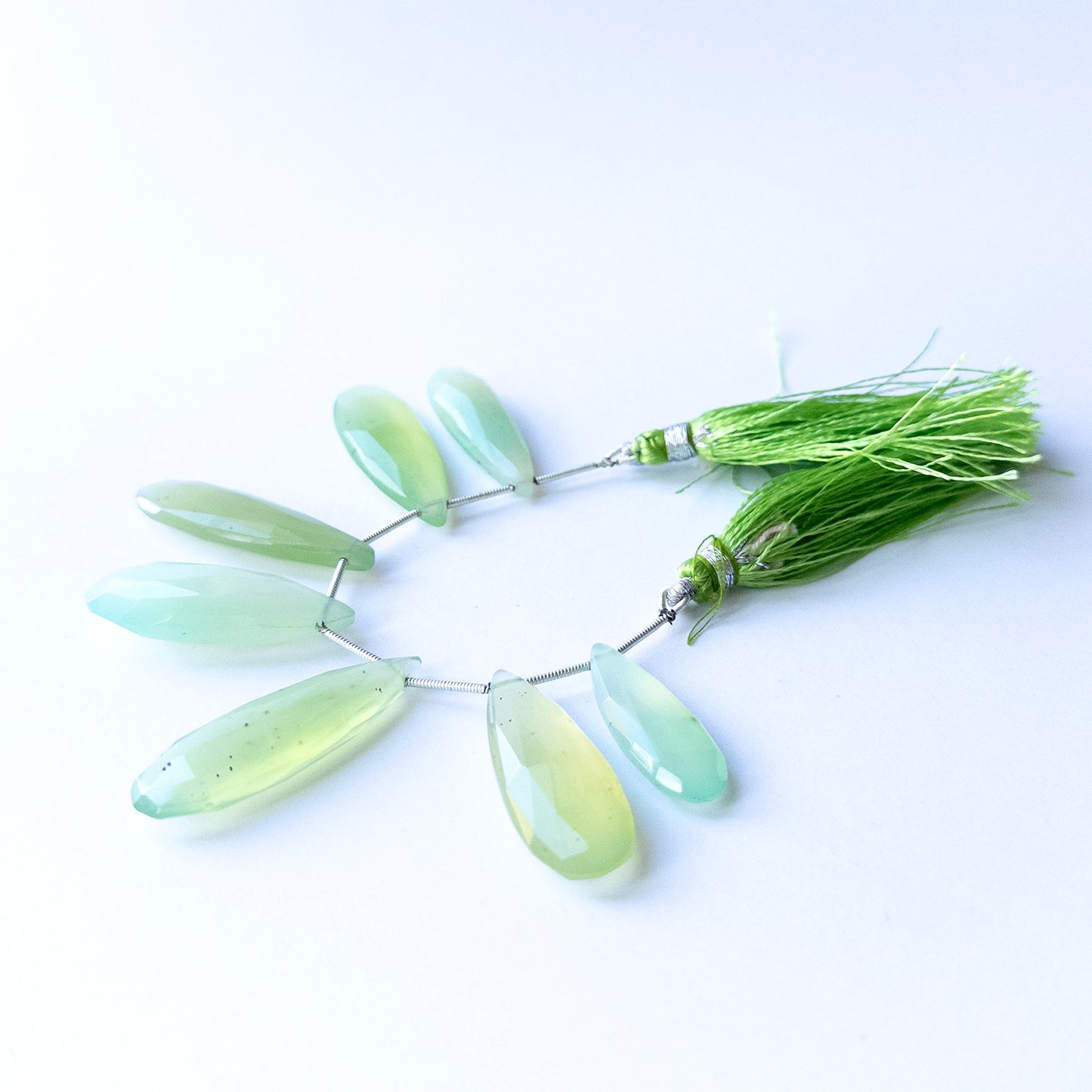 Handmade jewellery components featuring natural Chalcedony faceted briolettes, highlighting their clarity, colour, and elegant teardrop form.