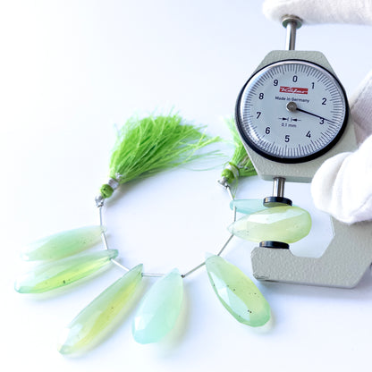 A dial gauge measures the Chalcedony faceted briolette 28–39mm gemstone.