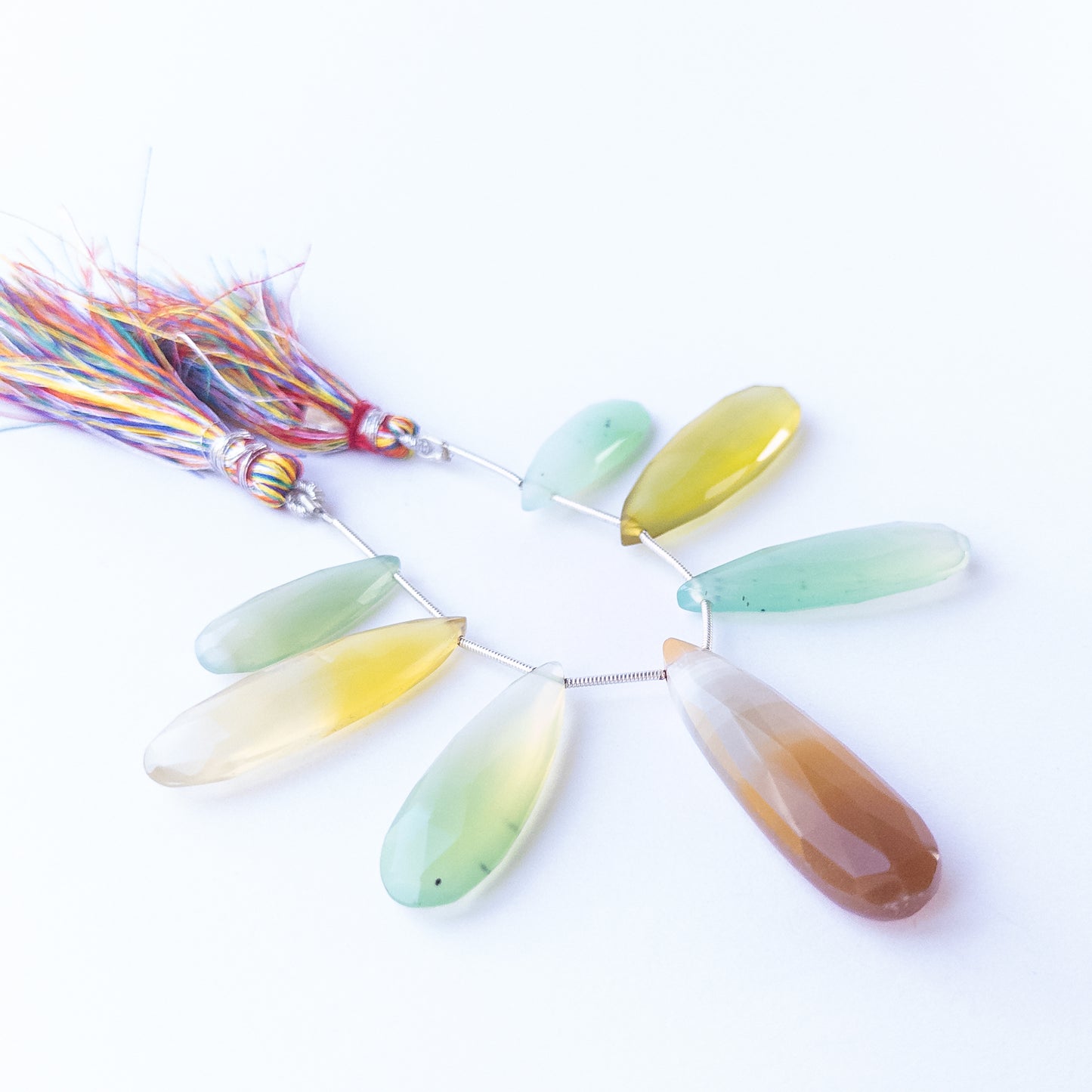 Natural Chalcedony faceted briolette stones displaying soft grey‑blue tones and elongated teardrop shapes.