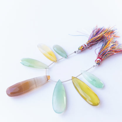 Close‑up of Chalcedony faceted briolette beads highlighting their sparkle, clarity and carved teardrop form.