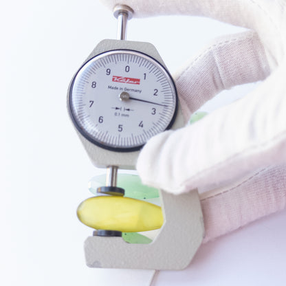 A dial gauge measures the Chalcedony faceted briolette 27–45mm × 10–14mm gemstone.