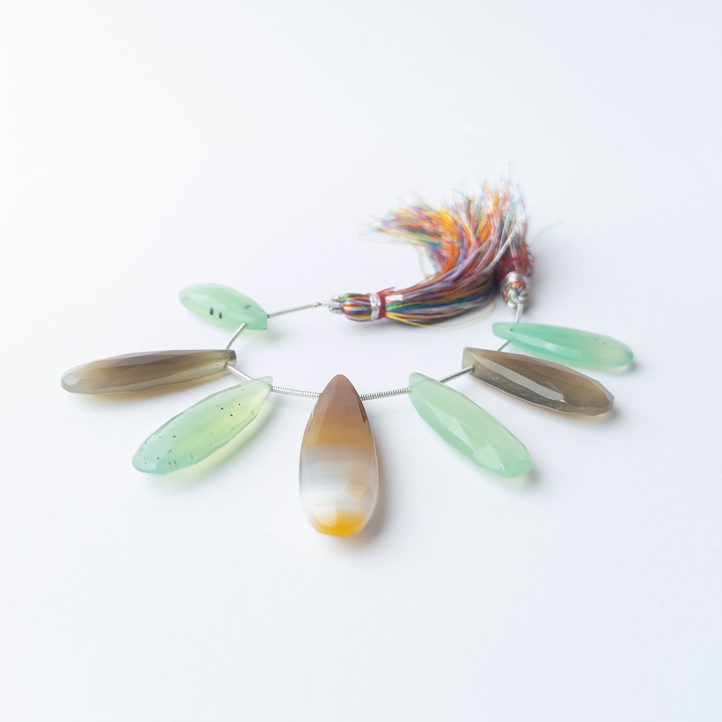 Chalcedony faceted briolette beads displaying natural colour variation and premium craftsmanship.