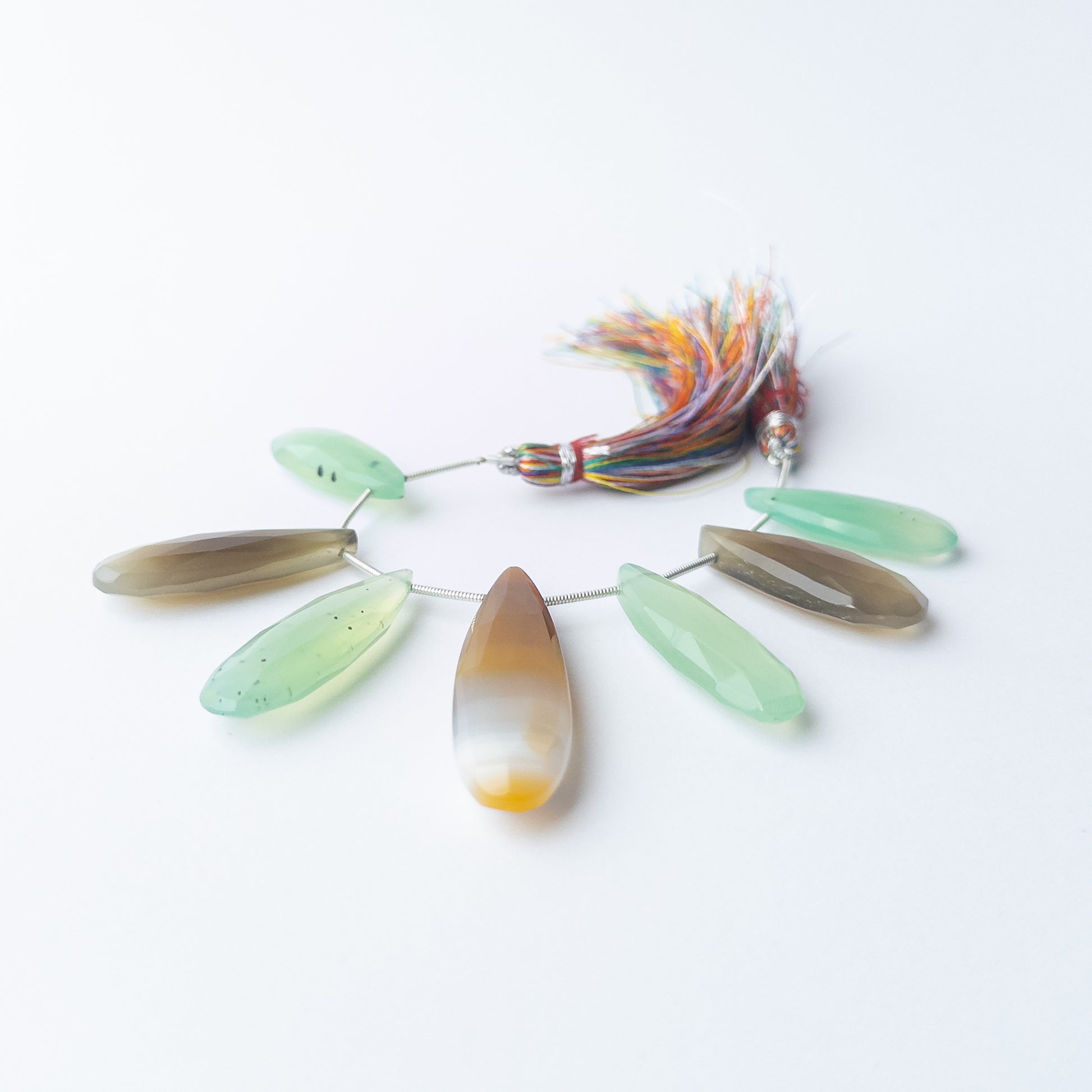 Chalcedony faceted briolette beads displaying natural colour variation and premium craftsmanship.