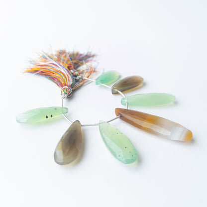 Chalcedony faceted briolette gemstone drops arranged in a soft blue strand for handmade jewellery making.