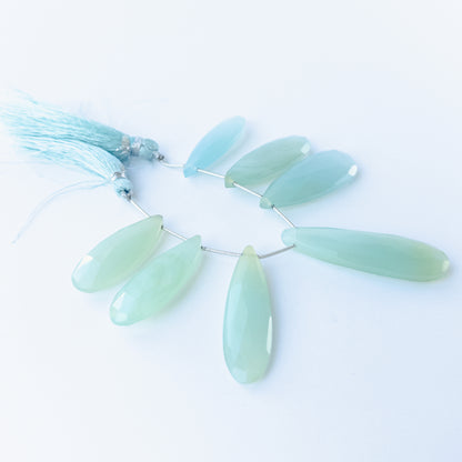 Chalcedony faceted briolette beads 29–45mm × 12–15mm shown as a set of six polished teardrop gemstones.