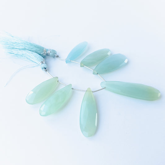 Chalcedony faceted briolette beads 29–45mm × 12–15mm shown as a set of six polished teardrop gemstones.