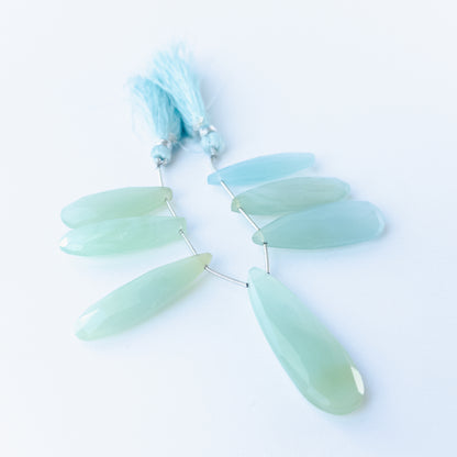 Natural Chalcedony faceted briolette stones displaying soft pastel tones and elongated teardrop shapes.