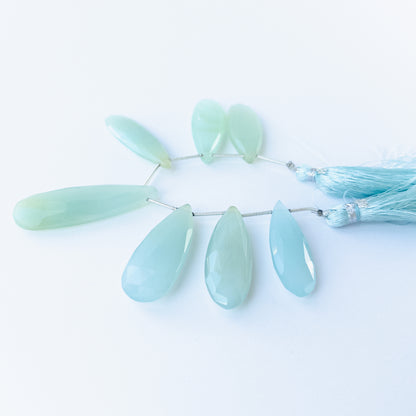 Close‑up of Chalcedony faceted briolette beads highlighting their sparkle, clarity and carved teardrop form.