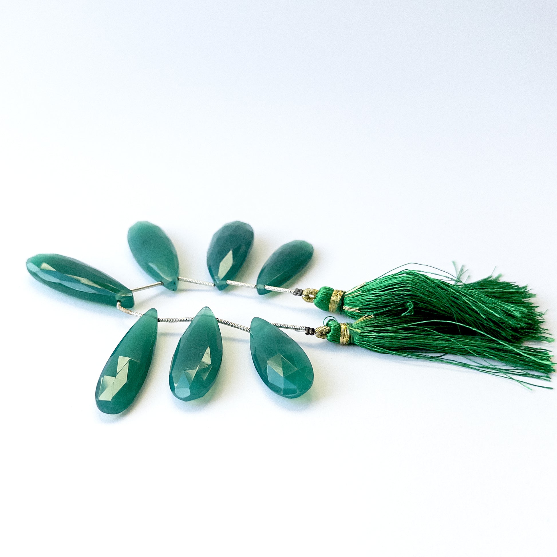 Genuine Chalcedony gemstone beads showcasing polished faceted briolette cuts in mixed 32–38mm lengths.