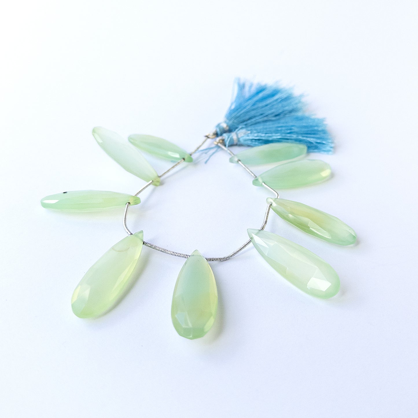 Genuine Chalcedony gemstone beads showcasing polished faceted briolette cuts in mixed 34–36mm lengths.