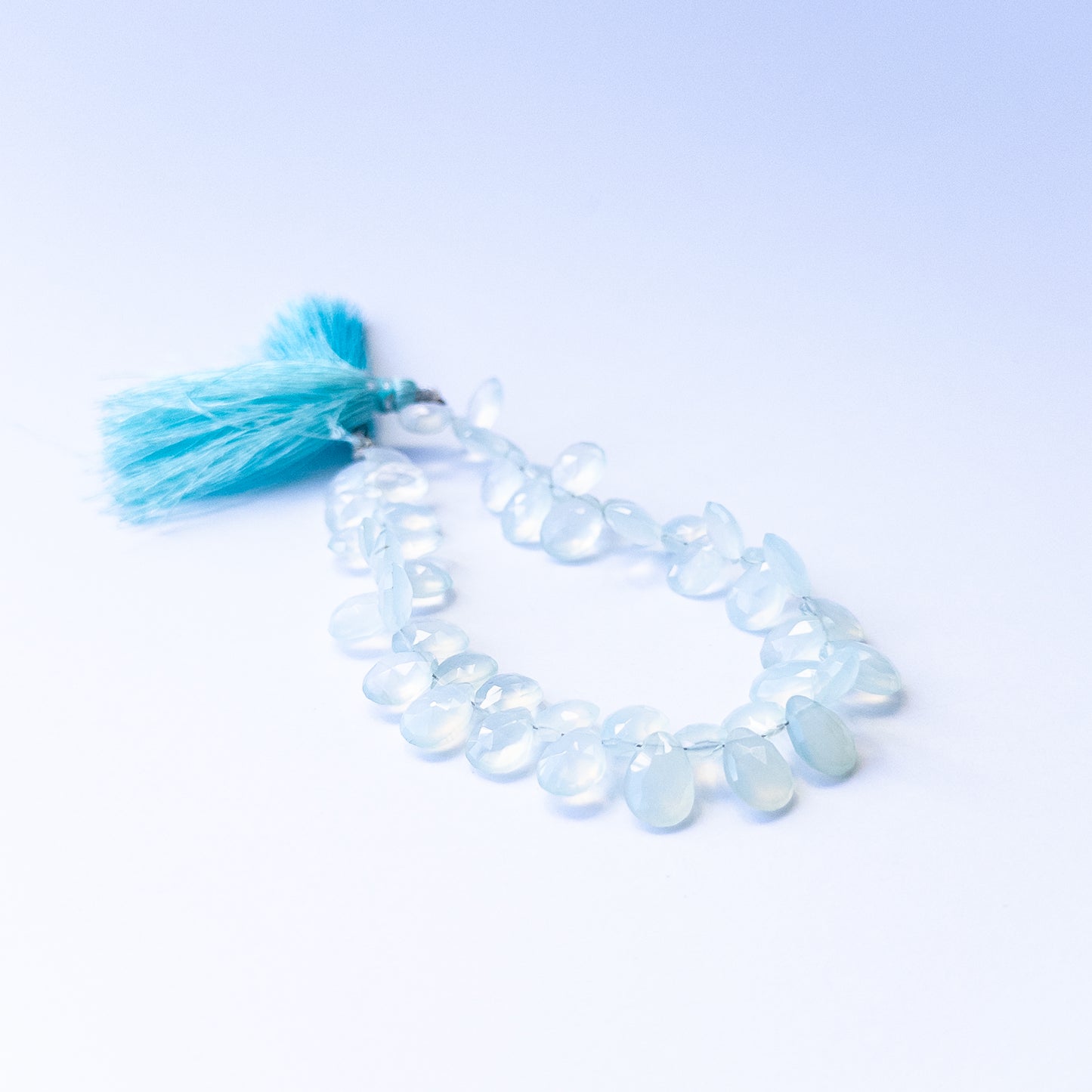 Natural Chalcedony stone beads with polished faceted briolette shapes, perfect for artisan jewellery designs.