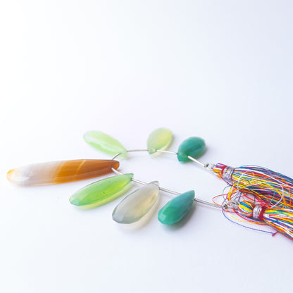 Close‑up of Chalcedony briolette beads showing their sparkle, clarity, and elegant teardrop shape.