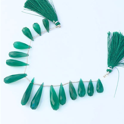 Stone beads made from green Chalcedony showing clean briolette cuts and smooth tapered forms.