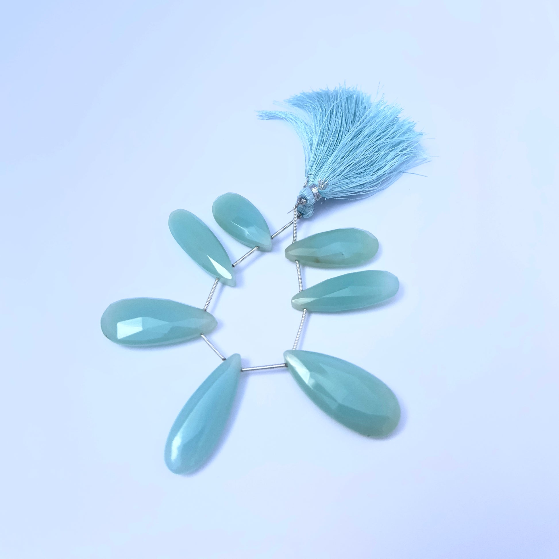 Natural Chalcedony stone beads arranged in a set of 7 with faceted finish.