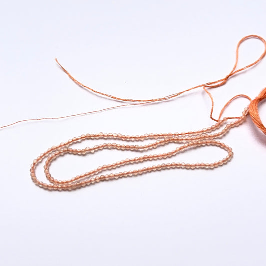 Close‑up of Chalcedony stone beads in tiny faceted rondelle cut, highlighting gentle shine for handmade jewellery components.