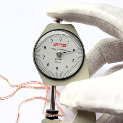 A dial gauge measures the Chalcedony faceted rondelle 1.9mm gemstone.