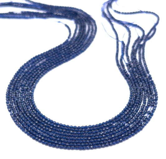 Close-up of a blue beaded necklace on a white background