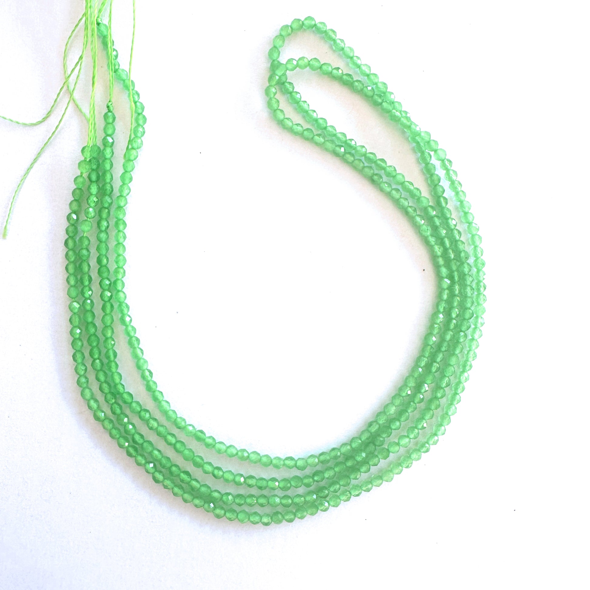 Chalcedony rondelle beads with faceted surfaces reflect light with subtle brilliance.