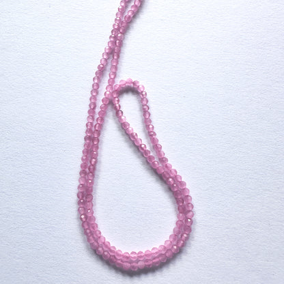 Close-up of Chalcedony beads showcasing their refined cut and gentle colour.