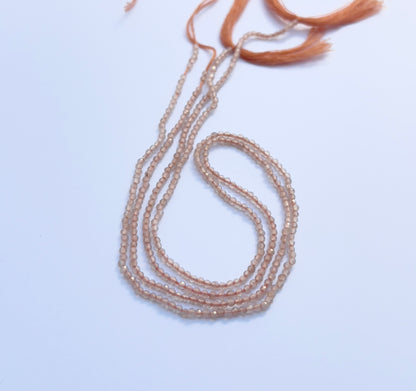 Close view of chalcedony stone beads, faceted rondelle 2mm, shimmering with soft translucent colour