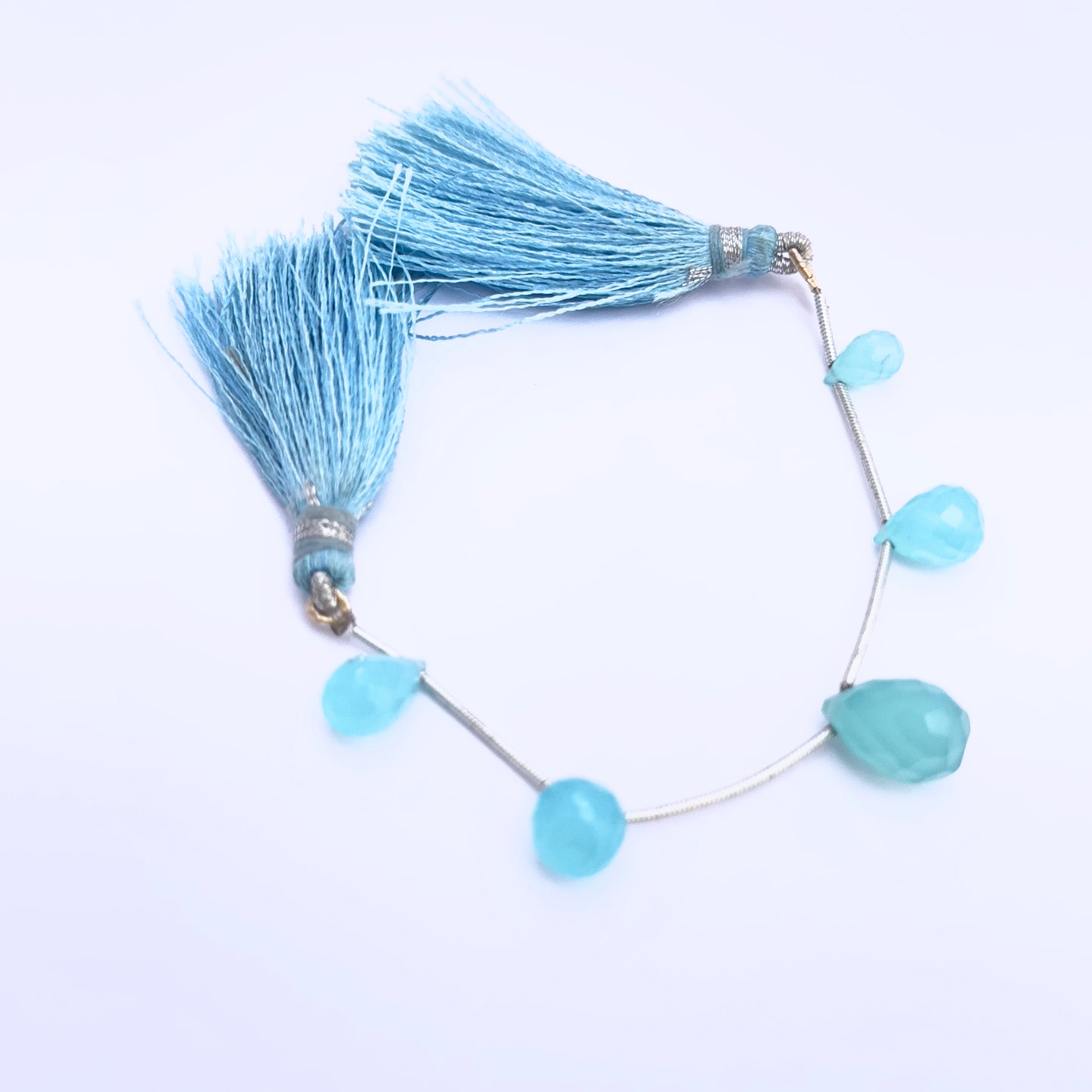Chalcedony gemstone beads for jewellery making displayed with soft lighting.