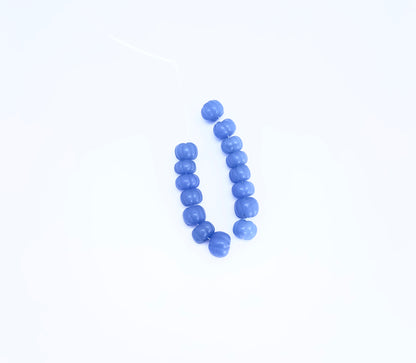 Close-up of Chalcedony gemstone beads showing smooth melon cut and translucent finish.