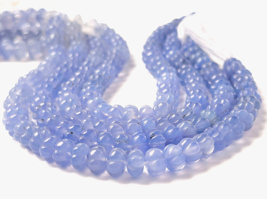 Chalcedony pumpkin‑cut gemstones with rounded ribbed carving and gentle pastel colouring across a compact 20cm strand.