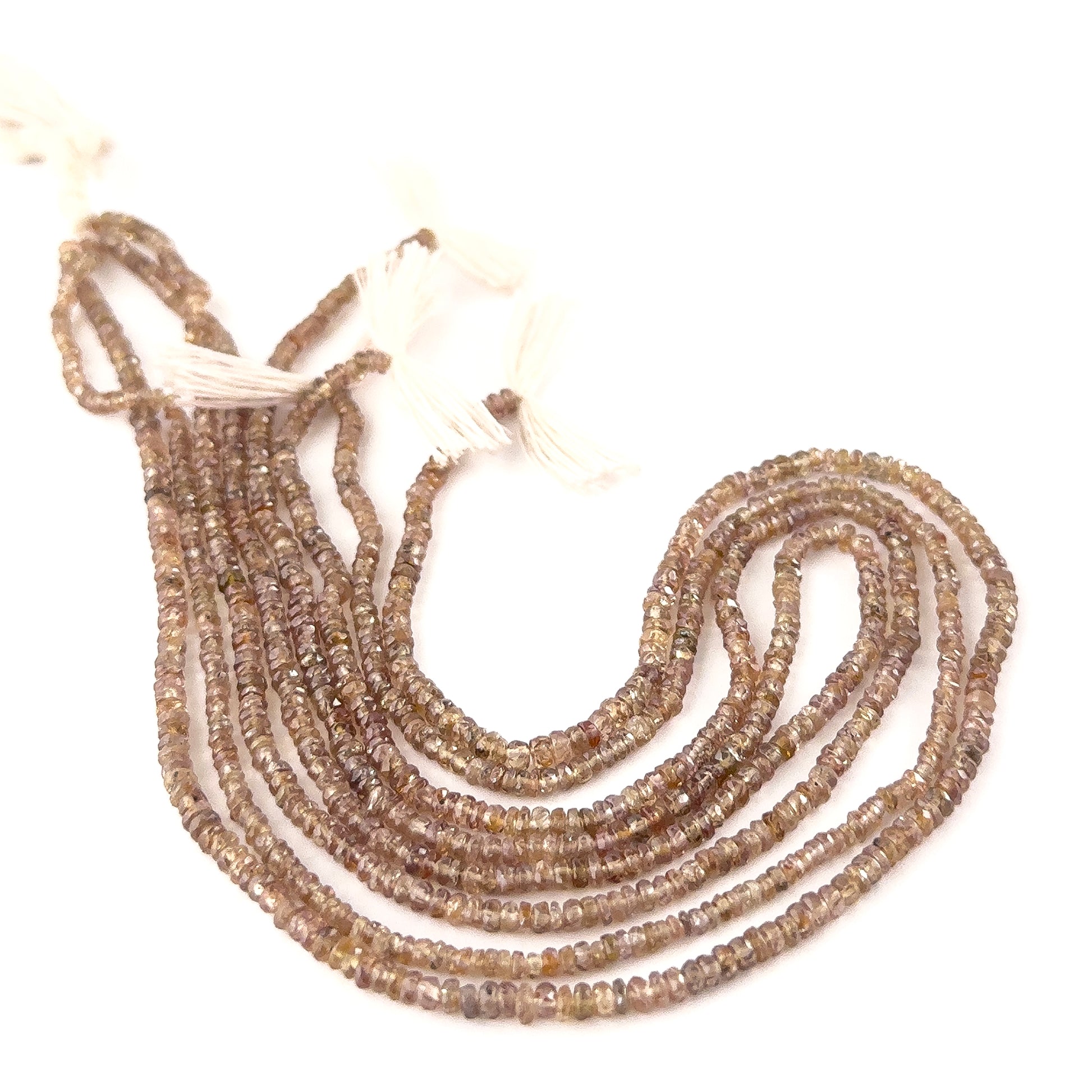 Close‑up of Change Garnet faceted rondelle beads highlighting their reflective facets and vivid tones.